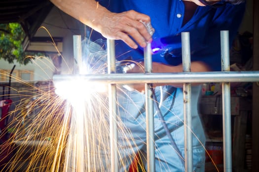 cllose-up welder at work without any safety gloves