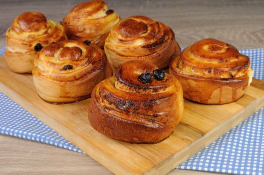 Freshly baked rolls in the form of a snail with raisins