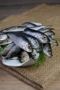 A pile of salted sprats in a bowl on the table