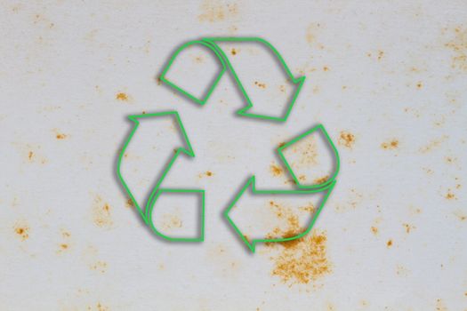 Old vintage paper with coffee stain in the middle, with green sign of recycle