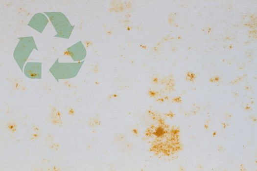 Old vintage paper with coffee stain in the middle, with symbol of recycle on the upper corner