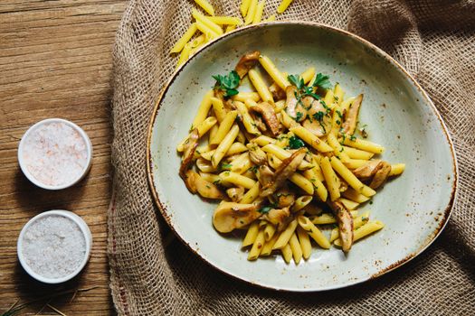 pasta penne with mushrooms grilled in sour cream sauce
