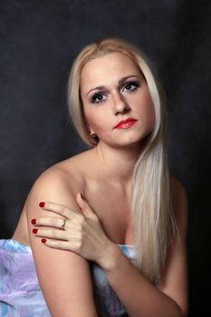 Beautiful young blond woman portrait in studio