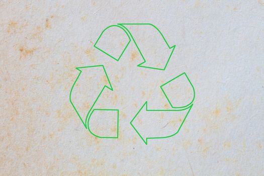 texture of old paper with yellow stain, background, with green sign of recycle