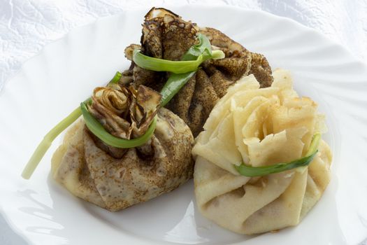 Blind with ham ,cheese and pickles tied green onions.