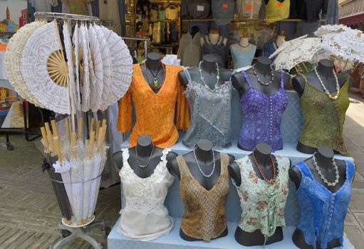 Clothes exposed on the outside of a store in Burano, an island in the Venetian Lagoon, Italy