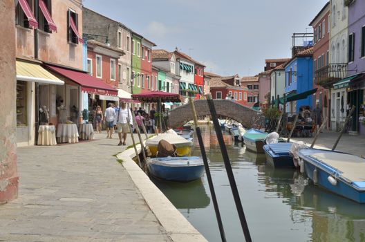 Brick bridge over a  small canal in Burano, a colorful island of Venice, Italy