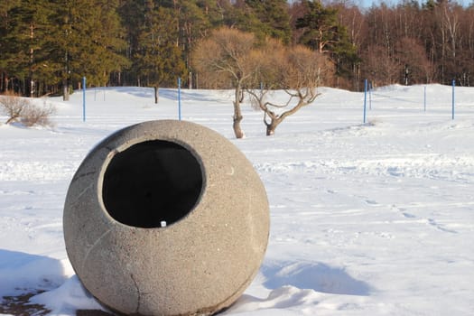 Winter landscape on the beach of Gulf of Finland with a concrete sculpture