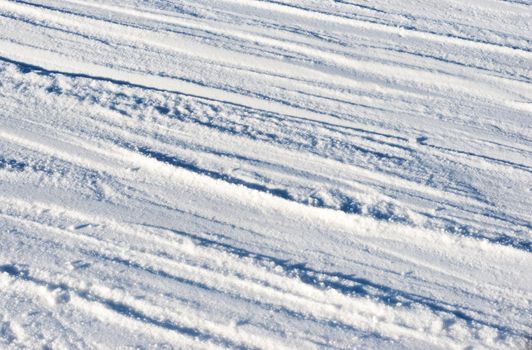 Closeup photo of skis marks on snow slope