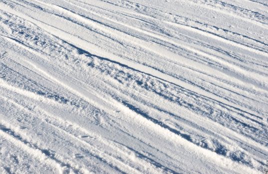 Closeup photo of skis marks on snow slope