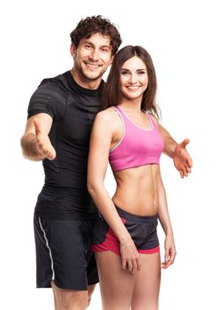 Sport couple - man and woman after fitness exercise on the white background