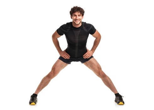Athletic attractive man doing  fitness exersise on the white background