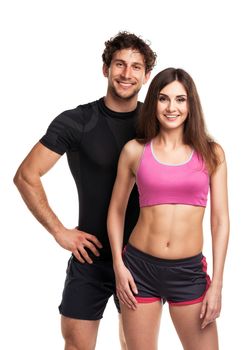 Sport couple - man and woman after fitness exercise on the white background