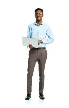 Happy african american college student with laptop standing on white background