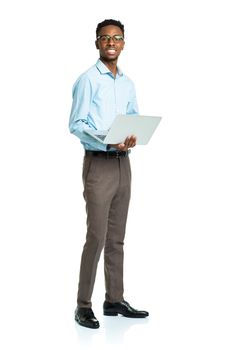 Happy african american college student with laptop standing on white background