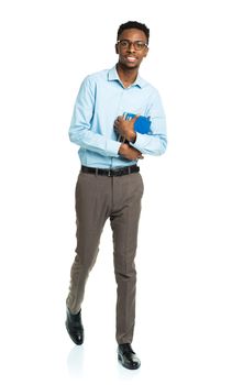 Happy african american college student with books in his hands  standing on white background