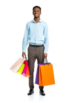 Happy african american man holding shopping bags on white background. Holidays concept