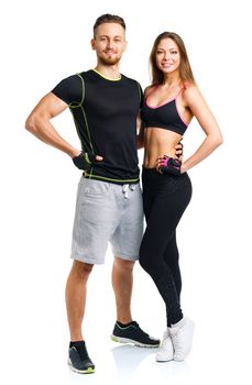 Sport couple - man and woman after fitness exercise on the white background