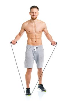 Athletic attractive man jumping on a rope on the white background