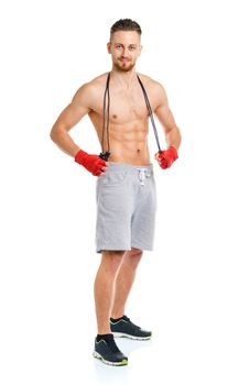 Athletic attractive man with a rope on the white background