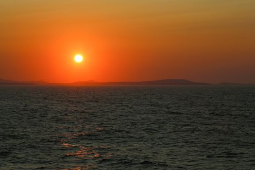 Sunset at the Portara Gate of the Apollo Temple in Naxos island