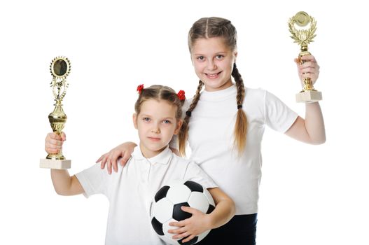 Little girls holding football ball and trophy isolated on white