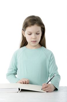 Little girl at the table in school isolated on white