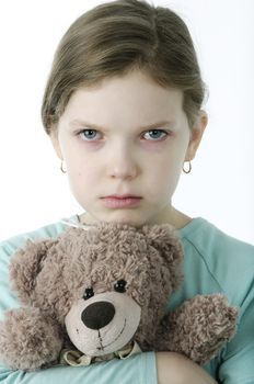 little girls cry holding teddy bear isolated on white