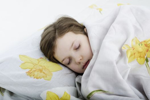 little girl sleeping in her bed