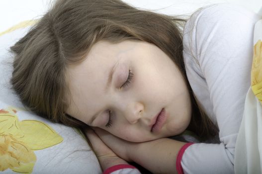 little girl sleeping in her bed