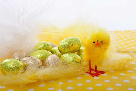 Easter scene with chicken and eggs on yellow napkin