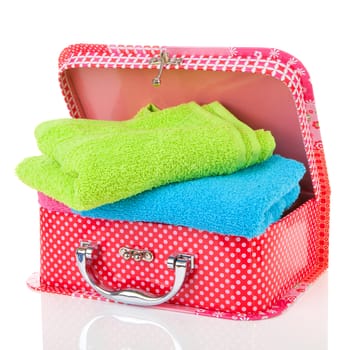 Suitcase and towels over white background