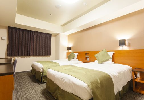 View of a luxury hotel room with two double beds