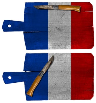 Old cutting boards with French flag and pen knife isolated on white background