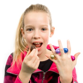 Girl with colorful easter eggs between fingers over white background