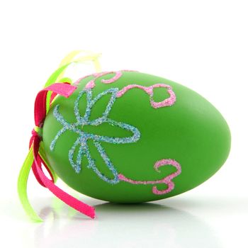 One green decorated easter egg over white background