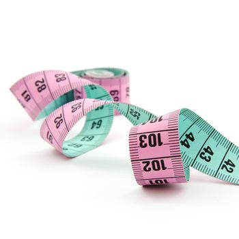colorful curly measure tape over white background