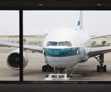 Osaka, Japan - Nov 7: A Cathay Pacific passenger airplane in the Kansai International Airport in Osaka, Japan on Nov 7, 2014. Cathay Pacific is an international airline based in Hong Kong. It provides passenger and cargo services to 168 destinations in 42 countries worldwide.