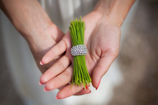 pine needles with a ring in the hands of a girl