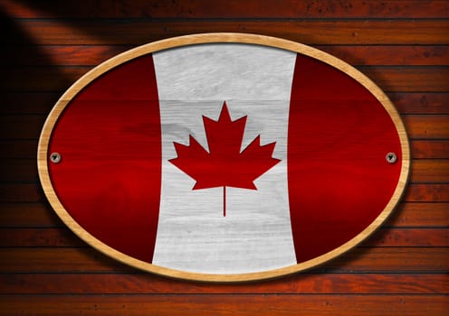 Oval wooden canadian flag with screws on a wooden wall with planks