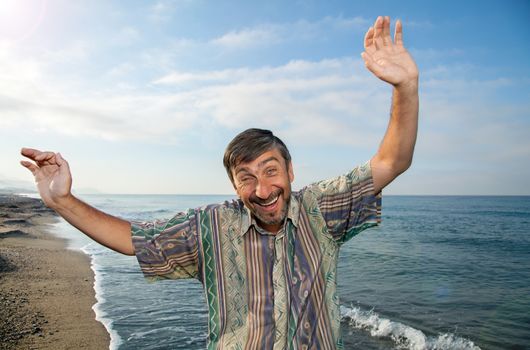 a middle aged man rejoices holiday at sea