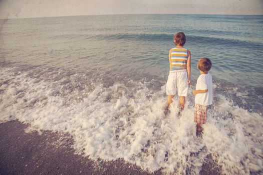 two boys looking at sea