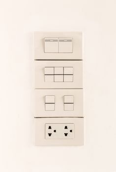 Electric light switches or switchboard and sockets on wall background, turn off position
