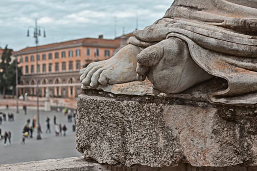 foot of a statue in Piazza del Popolo to Rome