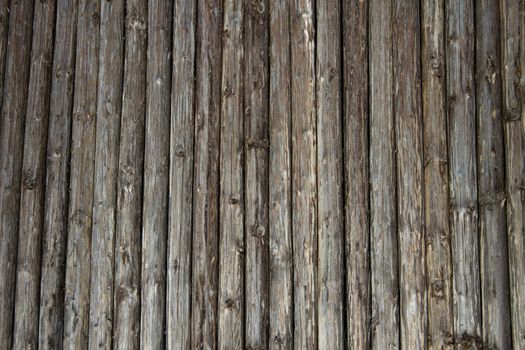 Wooden old untreated poles thick wall with natural background