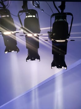 multiple spotlights on a theatre stage lighting rig