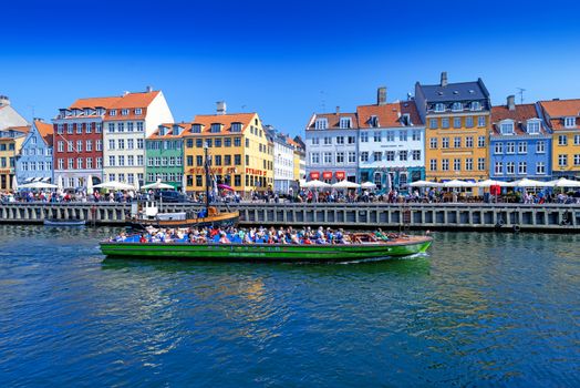 COPENHAGEN, DENMARK - MAY 18: unidentified people in open cafes of the famous Nyhavn promenade on May 18, 2013 in Copenhagen, Denmark. Nyhavn is one of the most famous landmark of Copenhagen.