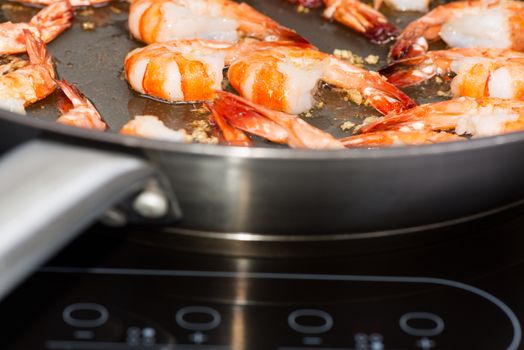 Chinese cooking: Shrimp in wok on cook top