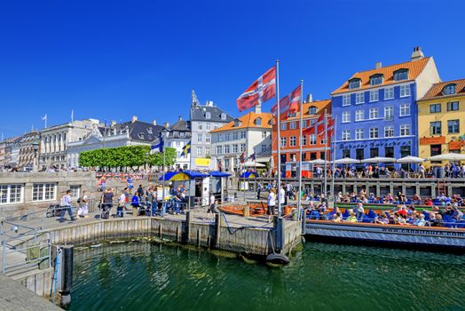 COPENHAGEN, DENMARK - MAY 18: unidentified people in open cafes of the famous Nyhavn promenade on May 18, 2013 in Copenhagen, Denmark. Nyhavn is one of the most famous landmark of Copenhagen.