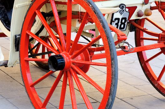 Red wooden coach wheel